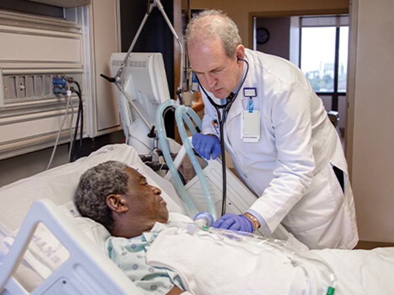 Patient with a cardiac condition being treated by a therapist at a critical illness hospital