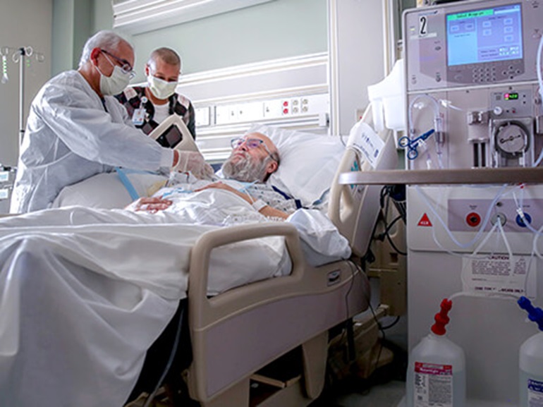 Patient needing renal care being treated by a therapist at a critical illness hospital